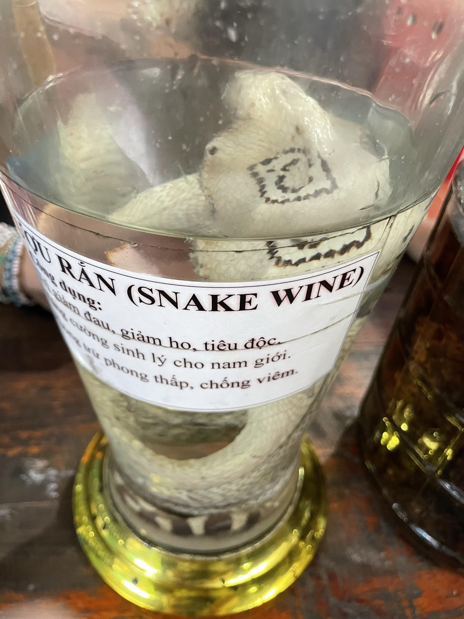 Rice wine offered by a local on Train Street, Hanoi